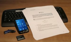 legal bill with electronic devices